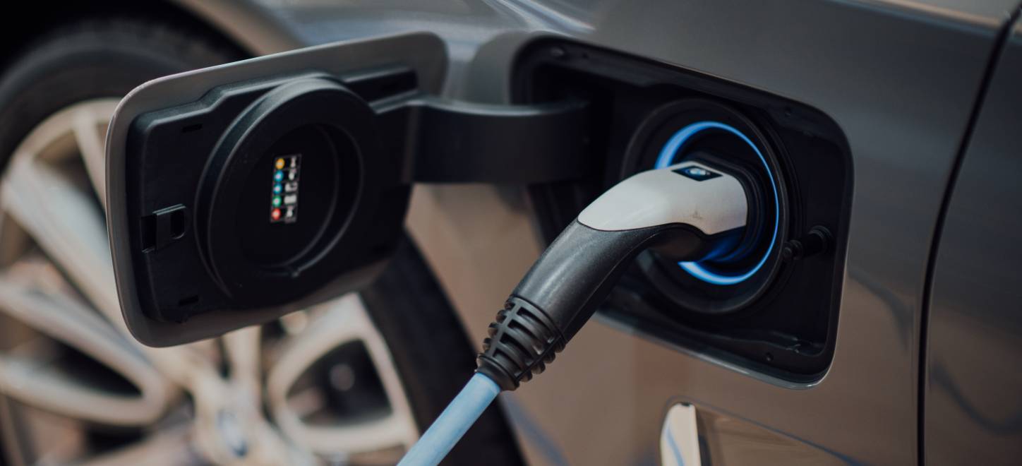 Close-up of a car plugged into an electric vehicle charger