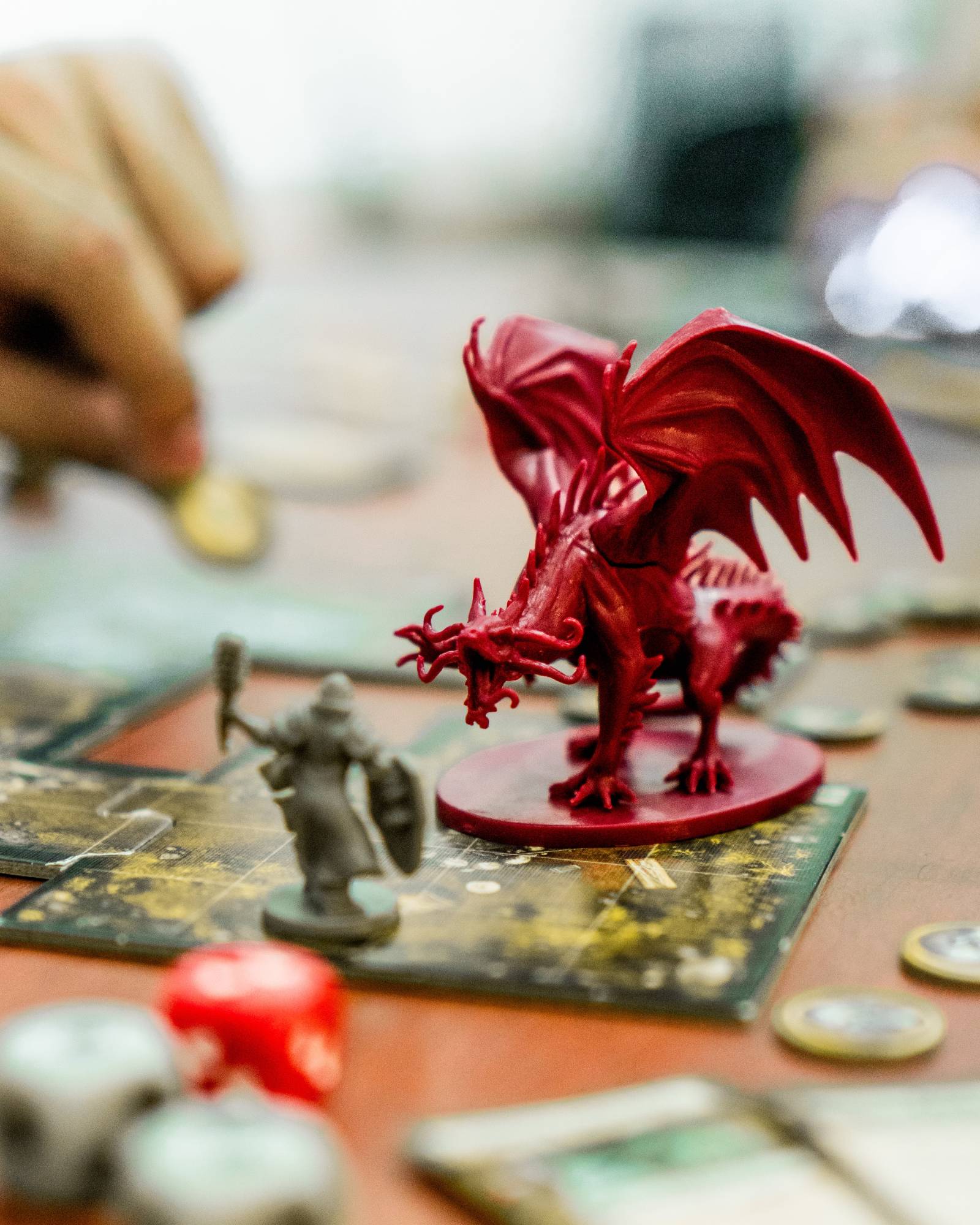 A red dragon action figure on table.