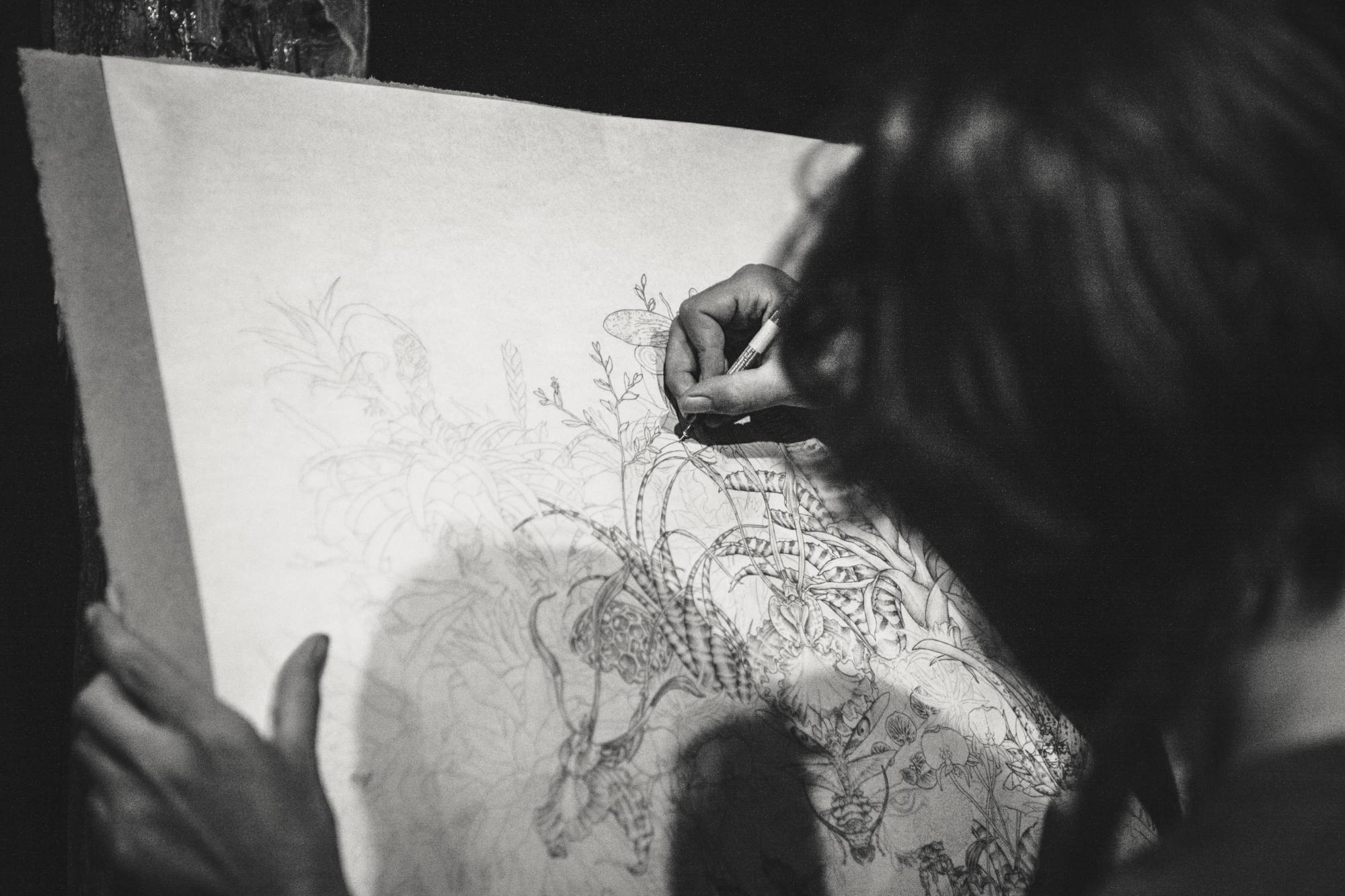 Woman drawing in pen 