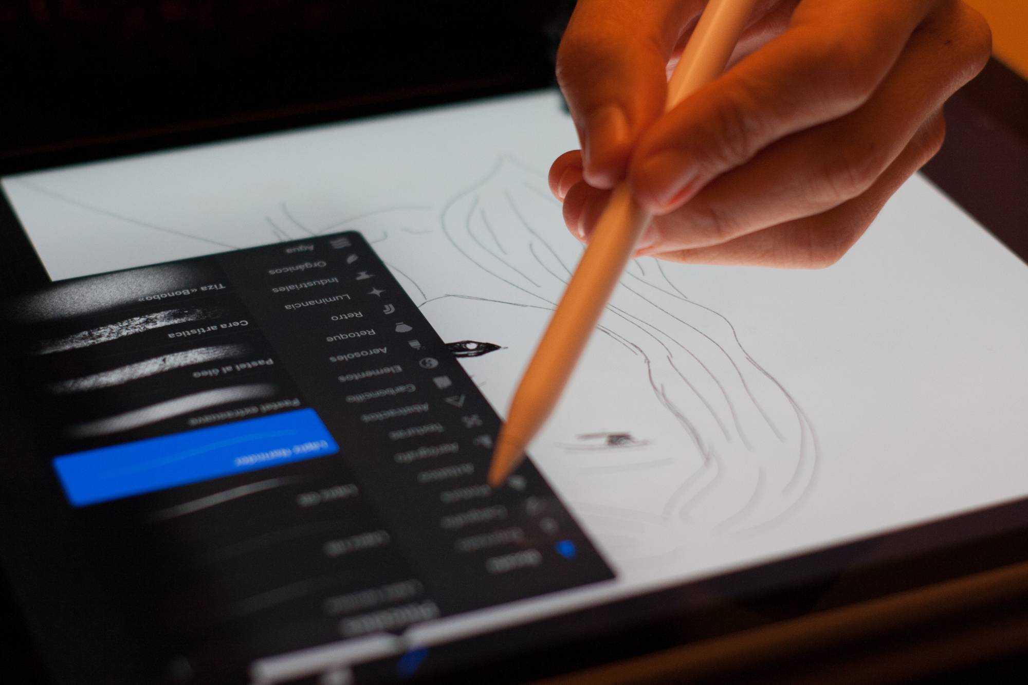 person drawing on digital tablet