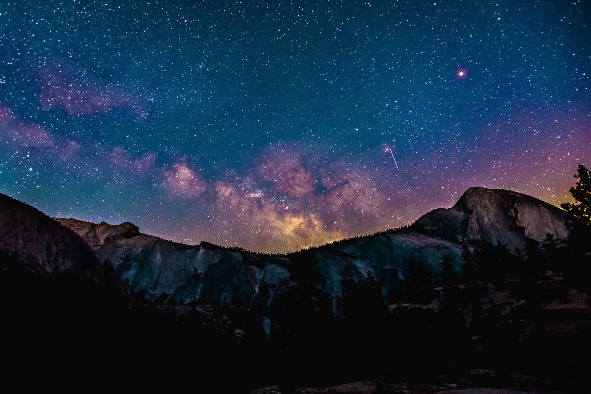 Starry night set behind mountain scape