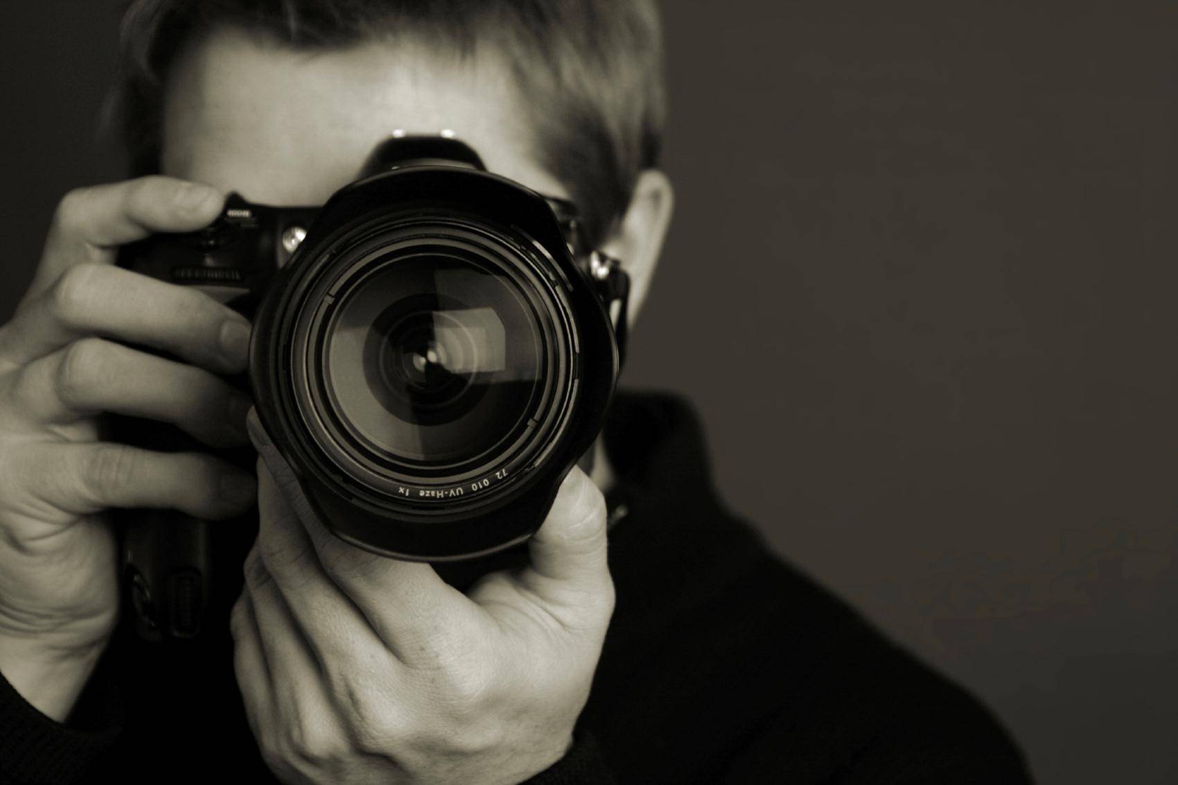 stock image - photographer with DSLR