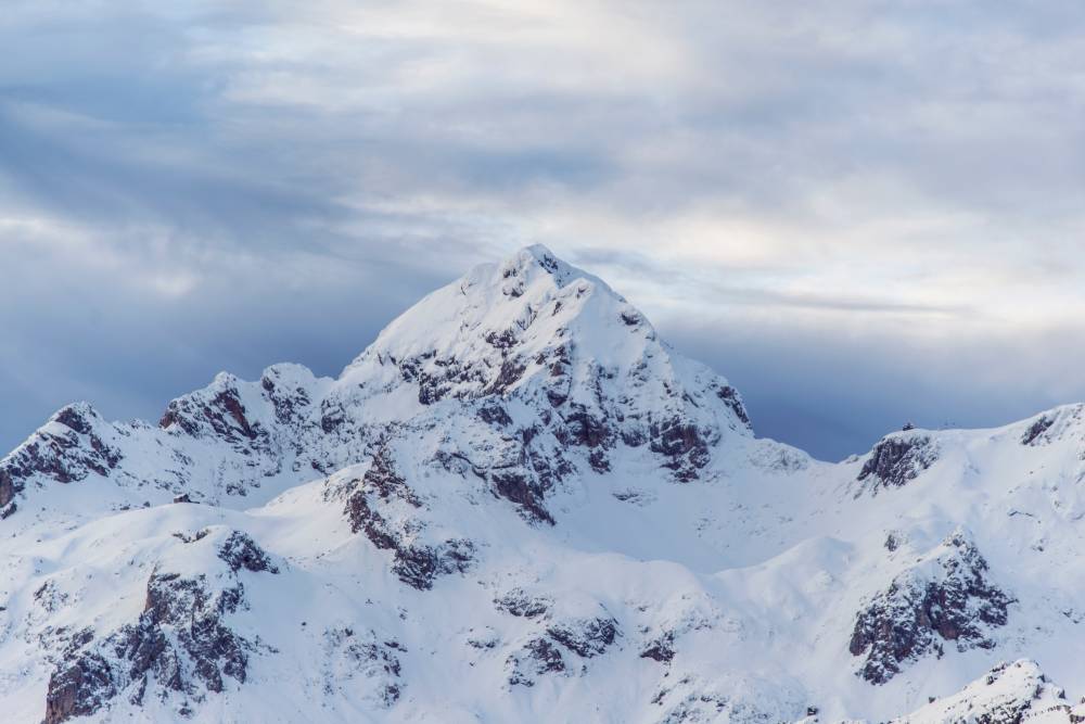 A photo of a snowy white mountain peak.