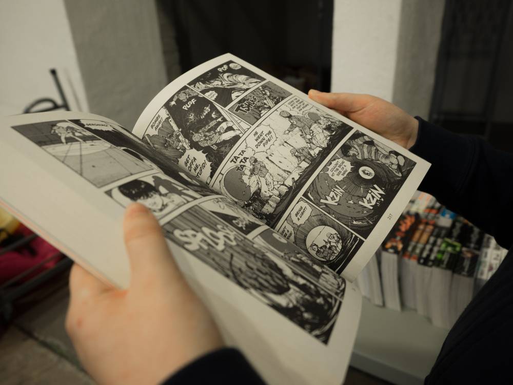 Person holding comic book