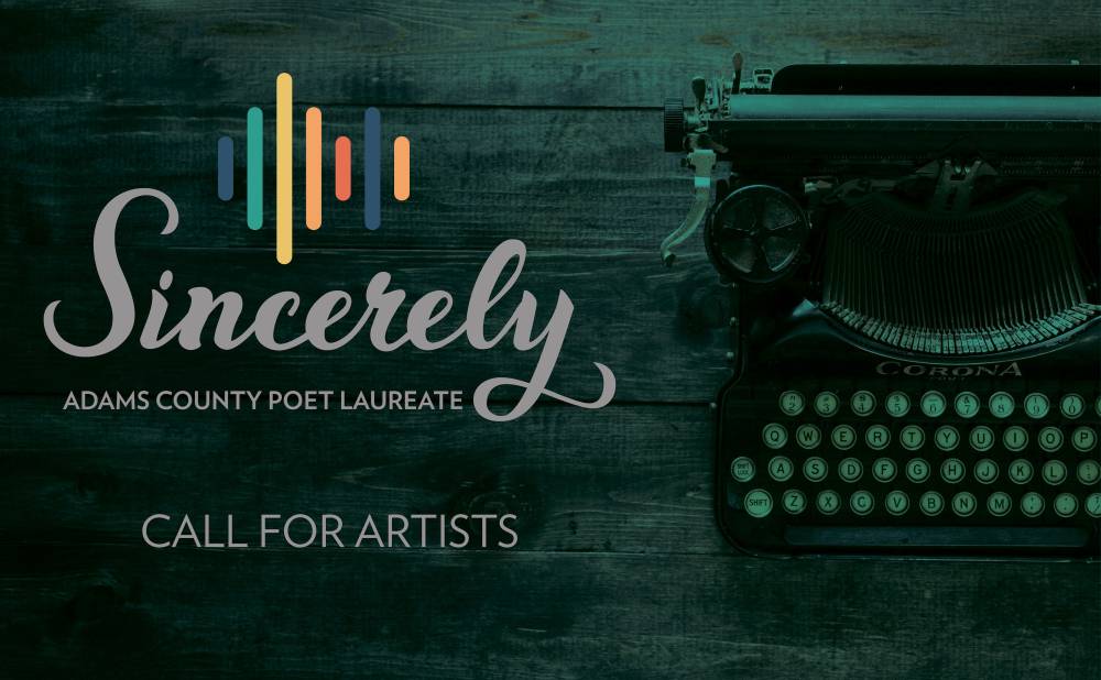 The logo for the Adams County Poet Laureate residency sits next to a typewriter.