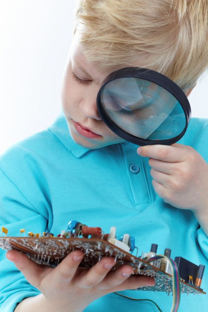 child looking at circuit board