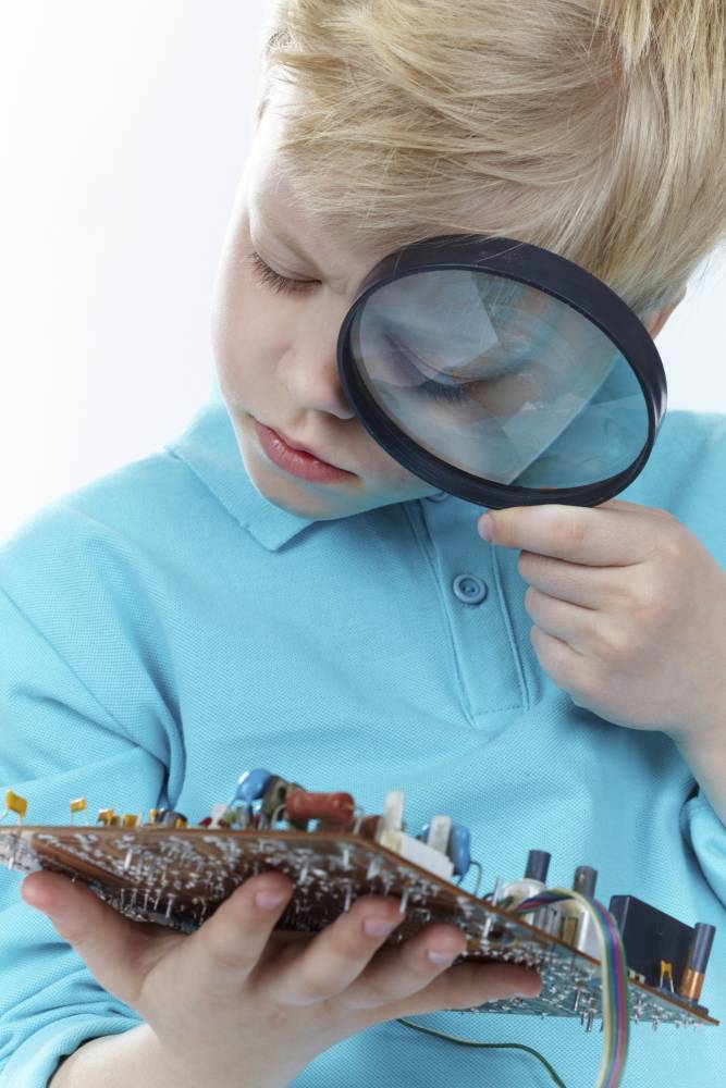 stock image - child investigating technology