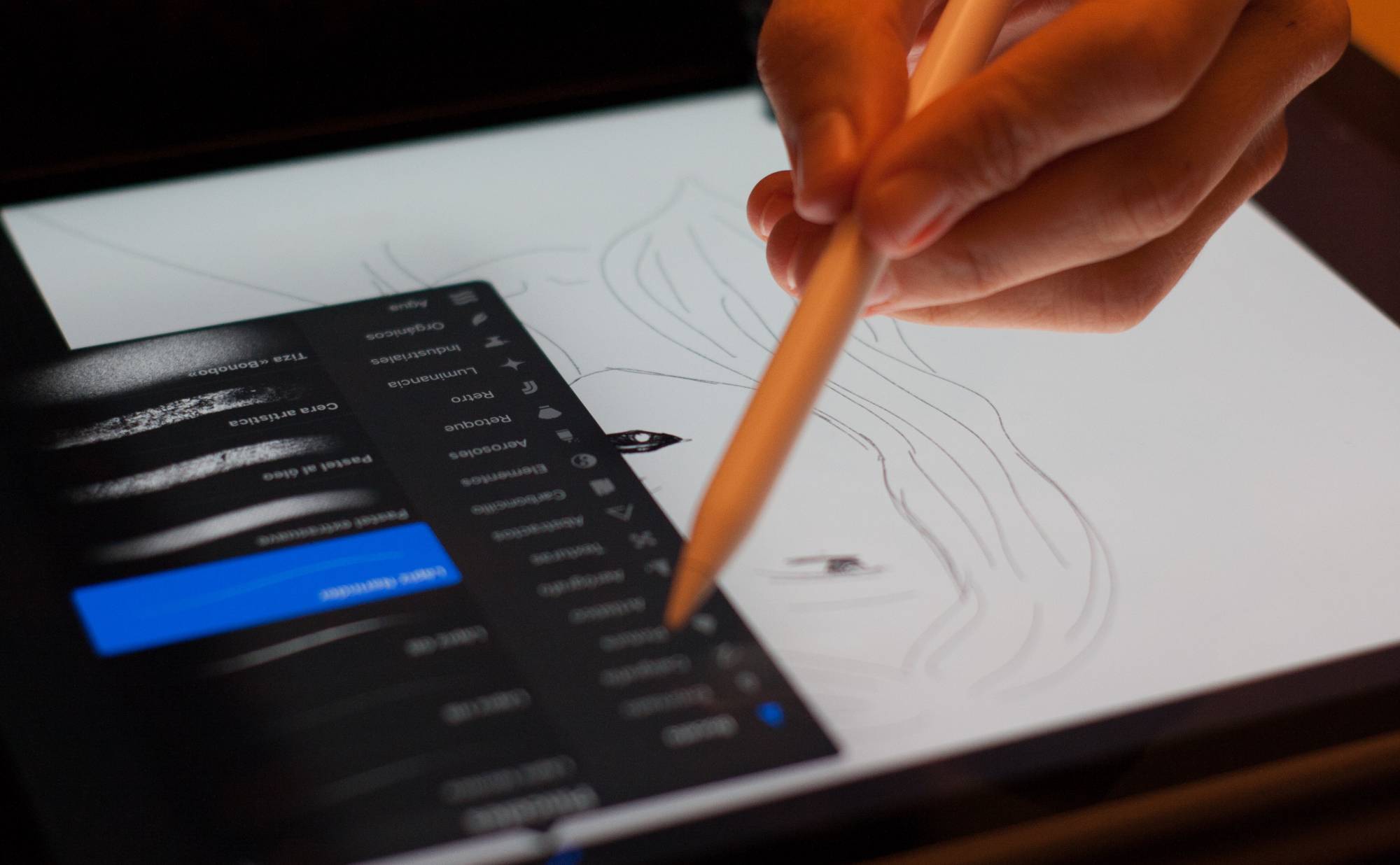 person drawing on digital tablet