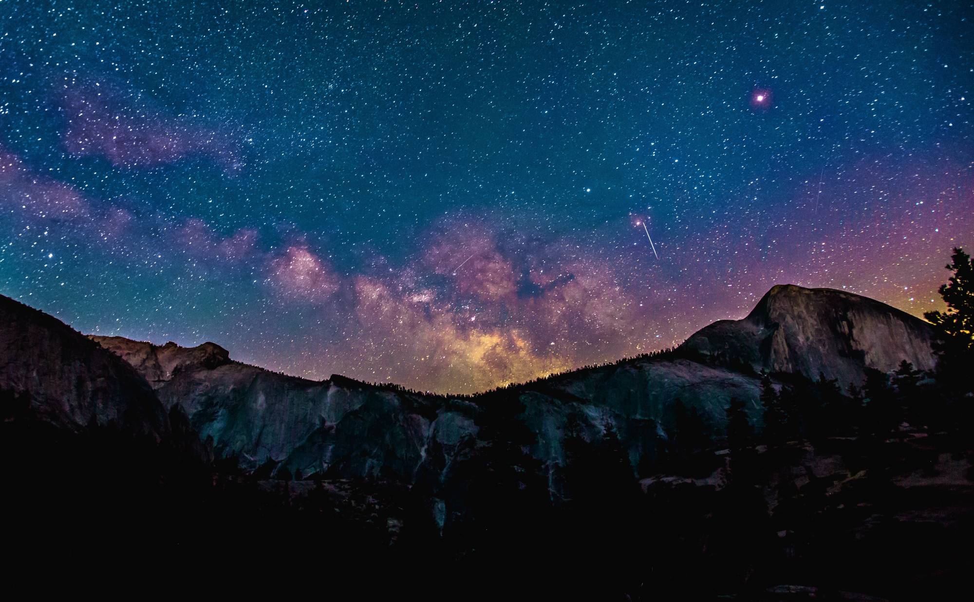 Starry night set behind mountain scape