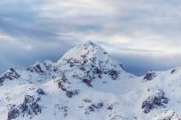 A photo of a snowy white mountain peak.