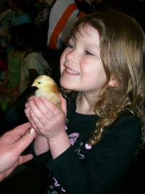 Young Anythinker Paige holds a baby chick