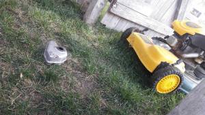 photo of a lawnmower with a missing part