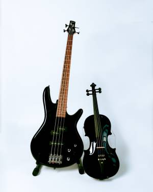 Black electric guitar and violin with white background.