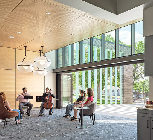 A flutist and a cello player perform for five library visitors at one of the Anythink Thornton Community Center's flexible use spaces.