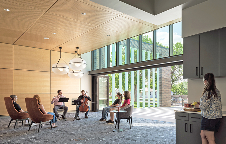 A flutist and a cello player perform for five library visitors at one of the Anythink Thornton Community Center's flexible use spaces.